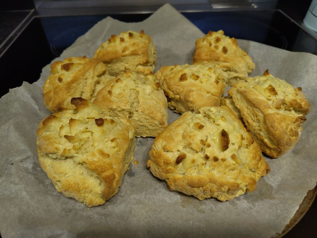 Eight quarters of scone, topped with cheese and baked. They're golden brown on top